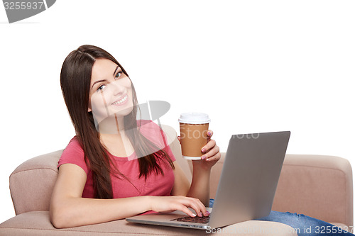 Image of Woman on sofa using laptop