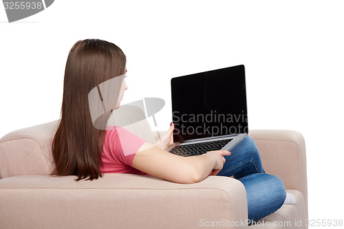 Image of Woman on sofa using laptop