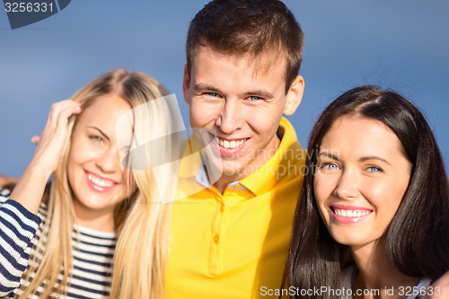 Image of group of happy friends over sky background