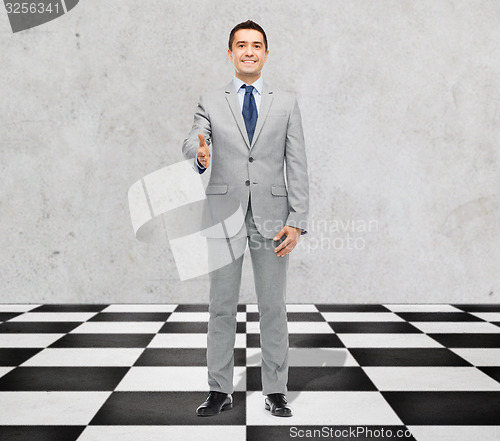 Image of happy smiling businessman in suit shaking hand