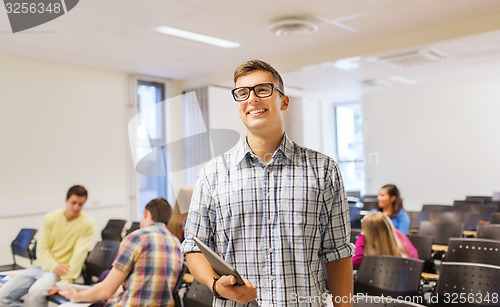 Image of group of smiling students in lecture hall