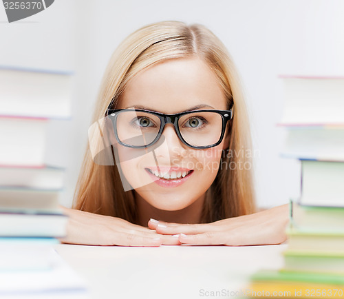 Image of student with stack of books