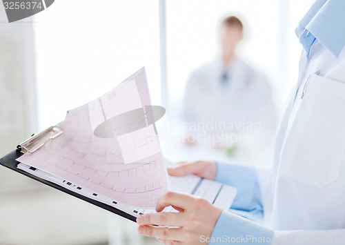 Image of female holding clipboard with cardiogram
