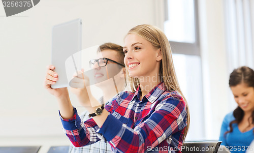 Image of group of smiling students with tablet pc