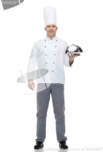 Image of happy male chef cook holding cloche