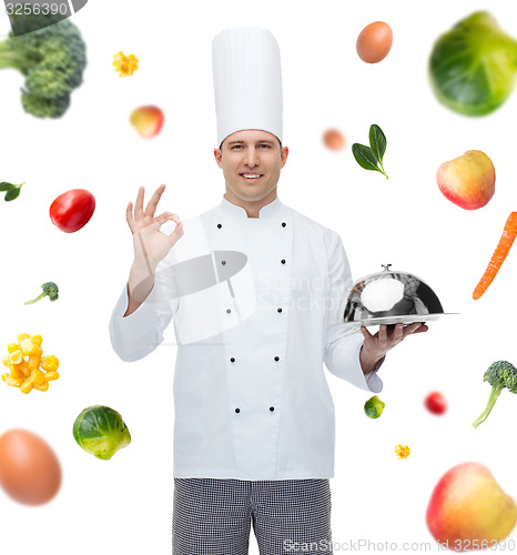 Image of happy male chef cook with cloche showing ok sign