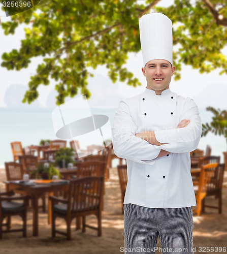 Image of happy male chef cook with crossed hands