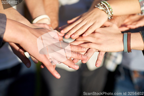 Image of close up of people hands on top