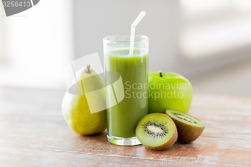 Image of close up of fresh green juice and fruits on table