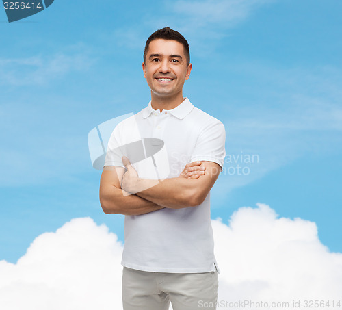 Image of smiling man in white t-shirt with crossed arms
