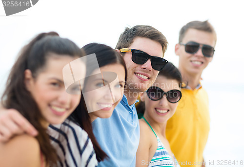Image of group of happy friends on beach