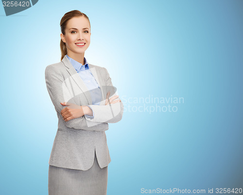 Image of smiling businesswoman with crossed arms