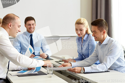 Image of business people with papers meeting in office