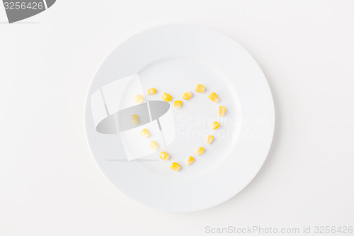 Image of close up of plate with corn  in heart shape 