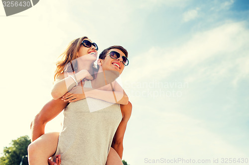 Image of smiling couple having fun over sky background