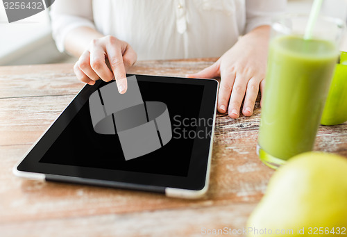 Image of close up of woman hands tablet pc and fruit juice