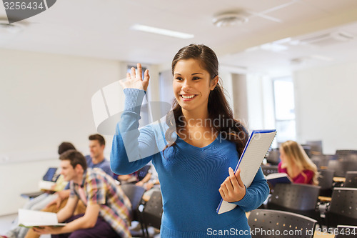 Image of group of smiling students in lecture hall