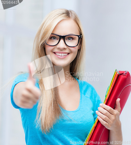 Image of smiling student with folders