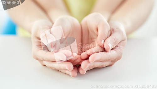 Image of close up of woman and girl with cupped hands