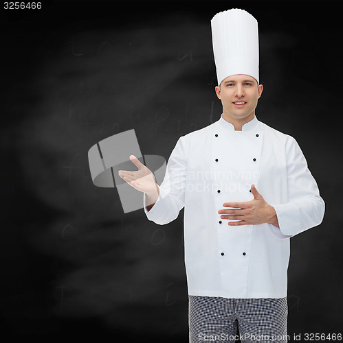 Image of happy male chef cook inviting