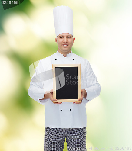 Image of happy male chef cook holding blank menu board