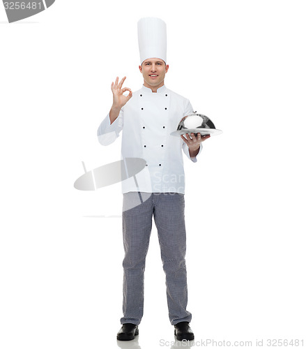 Image of happy male chef cook with cloche showing ok sign