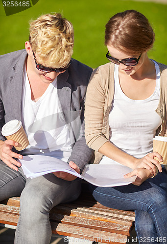 Image of happy student couple with notebook and coffee