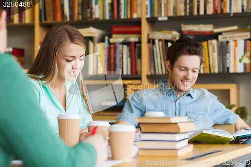 Image of students reading and drinking coffee in library