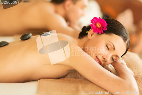 Image of couple in spa with hot stones