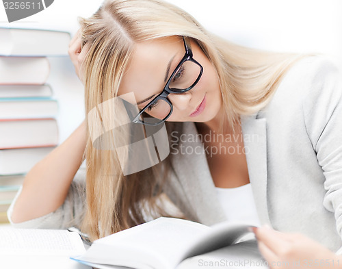 Image of student with books and notes