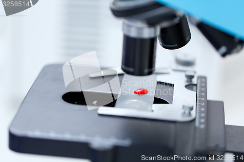 Image of close up of microscope and blood sample in lab