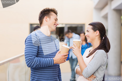 Image of group of smiling students with paper coffee cups