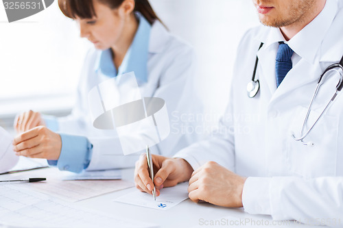 Image of doctor and nurse writing prescription paper