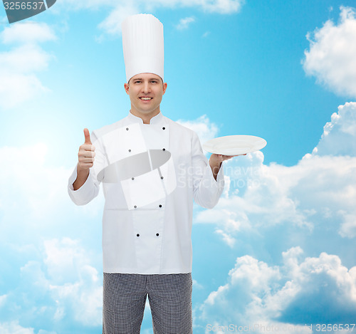 Image of happy male chef cook showing thumbs up and plate