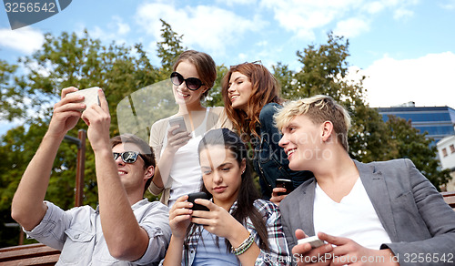 Image of students or teenagers with smartphones at campus