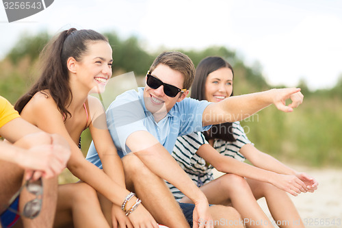 Image of group of happy friends on beach