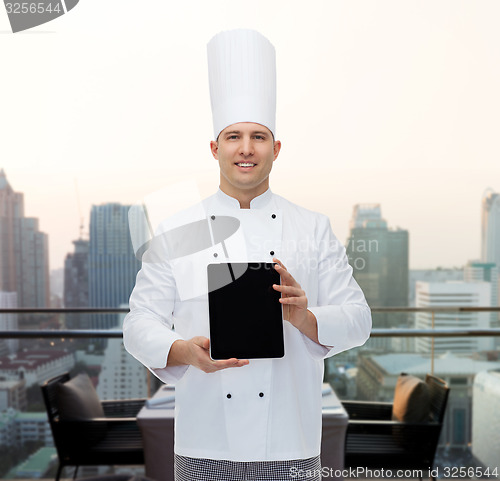 Image of happy male chef cook showing with tablet pc