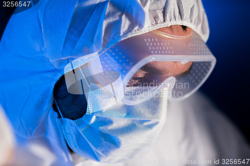 Image of close up of scientist face in chemical lab