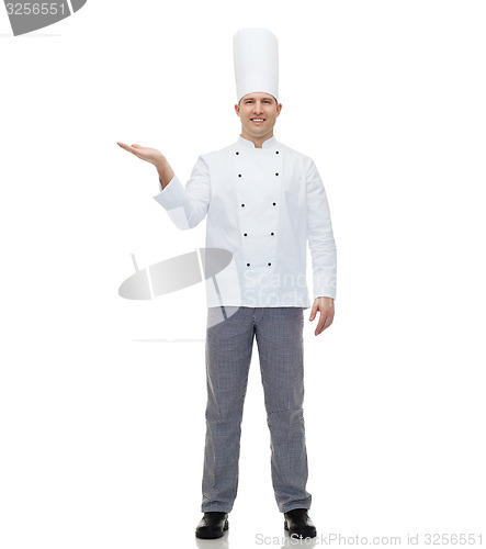 Image of happy male chef cook showing empty palm