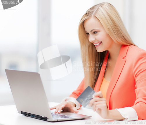 Image of businesswoman with laptop and credit card