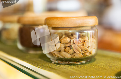 Image of close up of jars with peanuts at grocery store