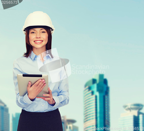 Image of young smiling businesswoman in white helmet