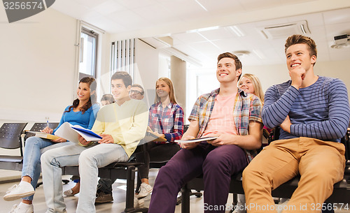 Image of group of smiling students in lecture hall