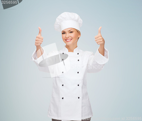 Image of smiling female chef showing thumbs up
