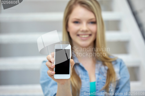 Image of close up of happy teenage girl showing smartphone