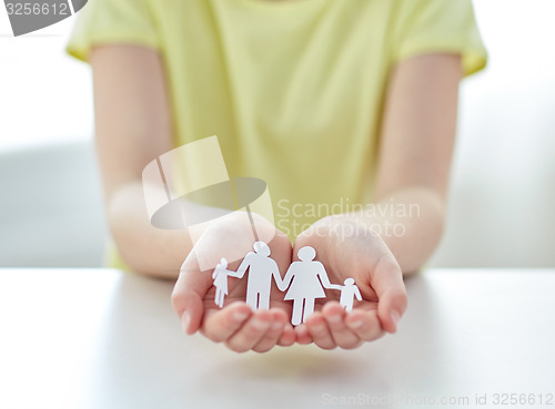 Image of close up of girl hands with paper family cutout