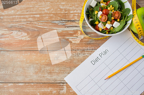 Image of close up of diet plan and food on table