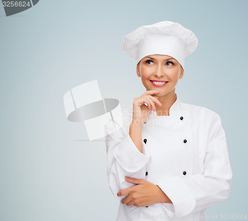 Image of smiling female chef dreaming