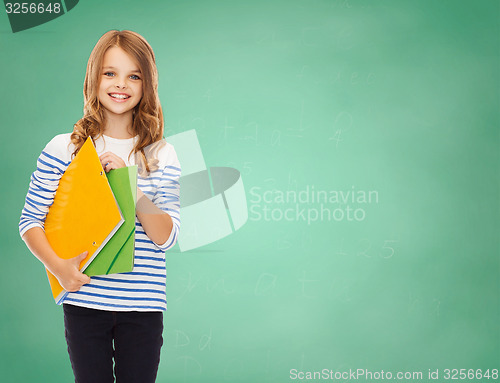 Image of happy girl holding colorful folders