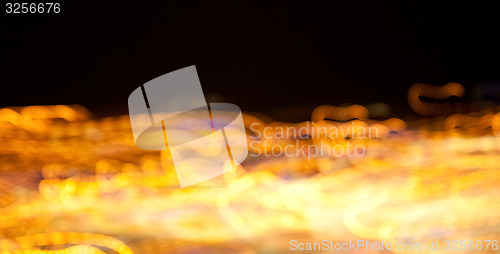 Image of golden bright lights on dark night background